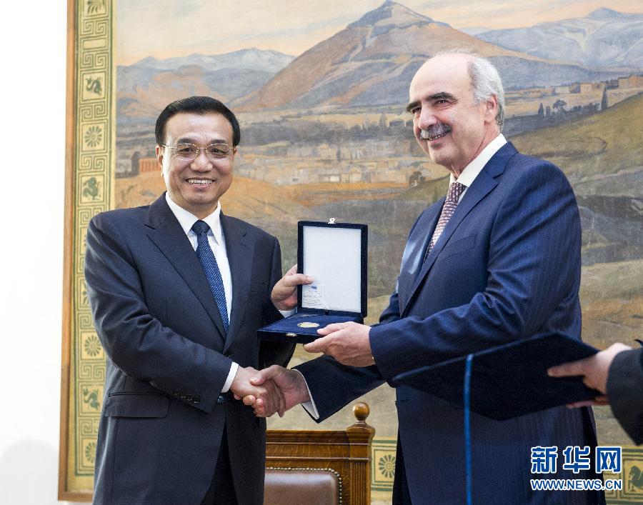 6月19日，國務院總理李克強在希臘議會大廈會見希臘議長米馬拉基斯。這是會見前，米馬拉基斯代表希臘議會向李克強授予議會金質(zhì)勛章。新華社記者 王曄 攝